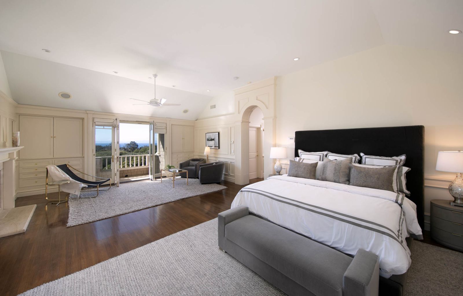 The bedroom sanctuary of a luxury home, with a view of the ocean and veranda